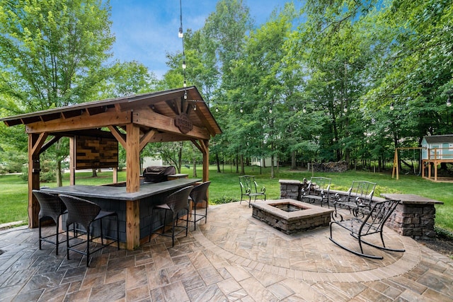 8918 Filiz Ln, Powell, OH 43065 - view of patio featuring an outdoor fire pit, a gazebo, and view of wooded area