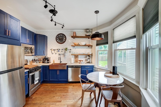 573 E Mithoff St, Columbus, OH 43206 - kitchen with blue cabinetry, appliances with stainless steel finishes, tasteful backsplash, and open shelves