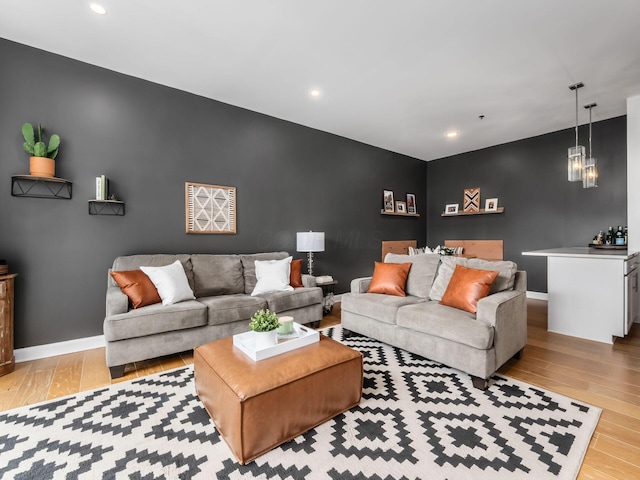 825 N 4th St Unit 215, Columbus, OH 43215 - living area with an accent wall, wood finished floors, and recessed lighting