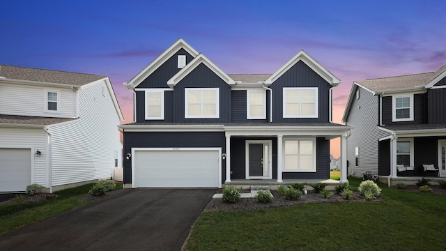 8145 Rhoderick Cir, Reynoldsburg, OH 43068 - traditional-style house with board and batten siding, a porch, a garage, asphalt driveway, and a lawn
