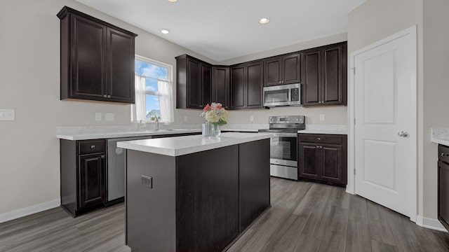 8145 Rhoderick Cir, Reynoldsburg, OH 43068 - kitchen with appliances with stainless steel finishes, wood finished floors, light countertops, dark brown cabinetry, and recessed lighting