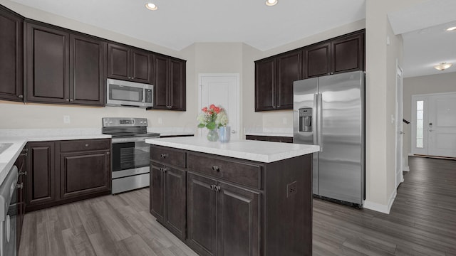 8145 Rhoderick Cir, Reynoldsburg, OH 43068 - kitchen featuring appliances with stainless steel finishes, wood finished floors, dark brown cabinetry, a center island, and recessed lighting