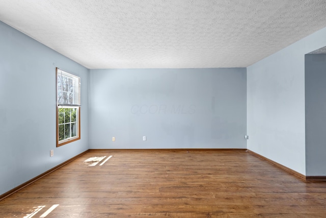 5722 Silver Spurs Ln, Galloway, OH 43119 - unfurnished room with wood finished floors and a textured ceiling