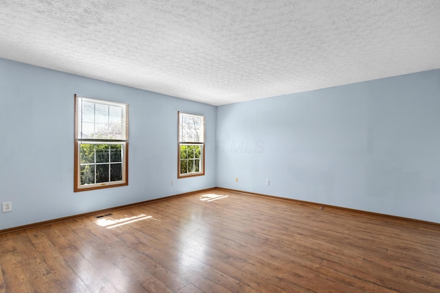 5722 Silver Spurs Ln, Galloway, OH 43119 - unfurnished room featuring wood-type flooring and a textured ceiling