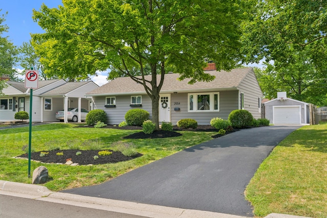 2554 Nottingham Rd, Upper Arlington, OH 43221 - ranch-style house featuring an outdoor structure, a front yard, asphalt driveway, and roof with shingles