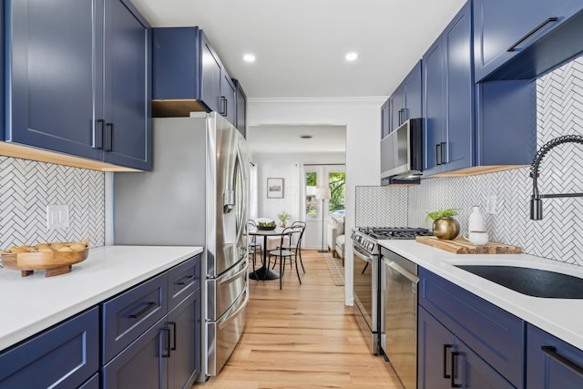 2554 Nottingham Rd, Upper Arlington, OH 43221 - kitchen featuring appliances with stainless steel finishes, light wood-style flooring, tasteful backsplash, light countertops, and recessed lighting