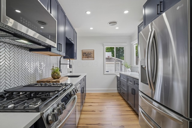 2554 Nottingham Rd, Upper Arlington, OH 43221 - kitchen featuring stainless steel appliances, light wood-style flooring, backsplash, light countertops, and recessed lighting