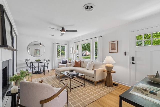 2554 Nottingham Rd, Upper Arlington, OH 43221 - living room featuring a fireplace, ceiling fan, light wood-style flooring, and crown molding