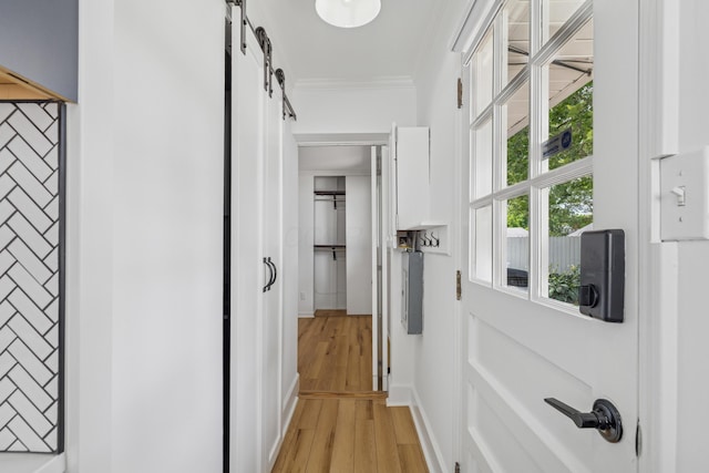 2554 Nottingham Rd, Upper Arlington, OH 43221 - hall with a barn door, ornamental molding, and light wood-type flooring