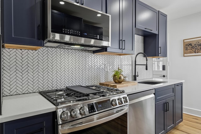 2554 Nottingham Rd, Upper Arlington, OH 43221 - kitchen with appliances with stainless steel finishes, backsplash, light countertops, light wood finished floors, and ornamental molding
