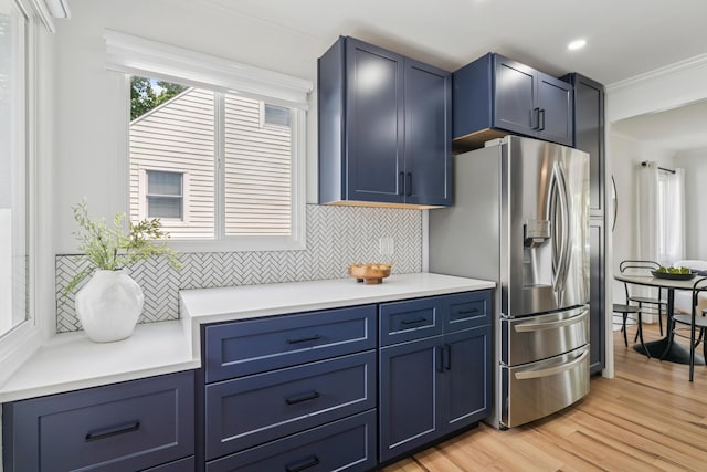 2554 Nottingham Rd, Upper Arlington, OH 43221 - kitchen featuring decorative backsplash, ornamental molding, blue cabinetry, stainless steel fridge with ice dispenser, and light wood finished floors