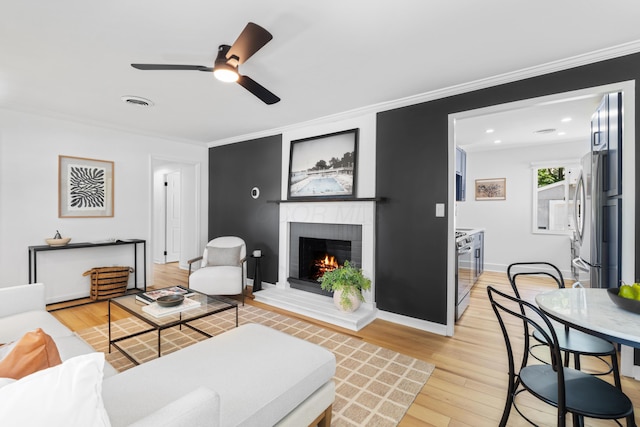 2554 Nottingham Rd, Upper Arlington, OH 43221 - living room with light wood-style floors, a fireplace, ornamental molding, a ceiling fan, and recessed lighting