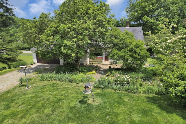 2083 Welsh Hills Rd, Granville, OH 43023 - view of front of house with a front yard, driveway, a chimney, and an attached garage