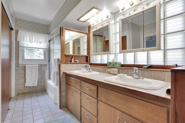 2083 Welsh Hills Rd, Granville, OH 43023 - bathroom featuring tile patterned flooring, double vanity, shower / bath combination with glass door, and tile walls