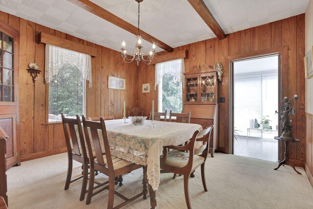 2083 Welsh Hills Rd, Granville, OH 43023 - dining space with wood walls, beamed ceiling, light carpet, and a chandelier