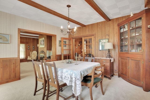 2083 Welsh Hills Rd, Granville, OH 43023 - dining area with light carpet, a chandelier, beam ceiling, wood walls, and wallpapered walls