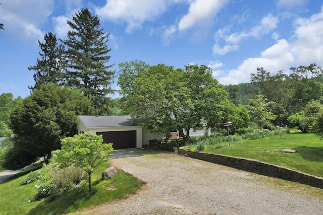2083 Welsh Hills Rd, Granville, OH 43023 - obstructed view of property with driveway, a garage, and a front lawn