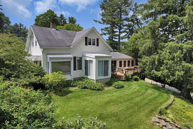 2083 Welsh Hills Rd, Granville, OH 43023 - view of front of house featuring a deck, a chimney, a front yard, and a shingled roof