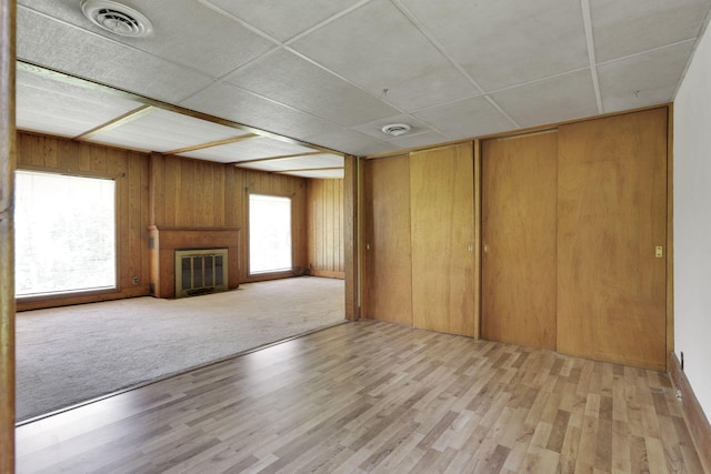 2083 Welsh Hills Rd, Granville, OH 43023 - unfurnished living room featuring a glass covered fireplace, wood finished floors, and wood walls