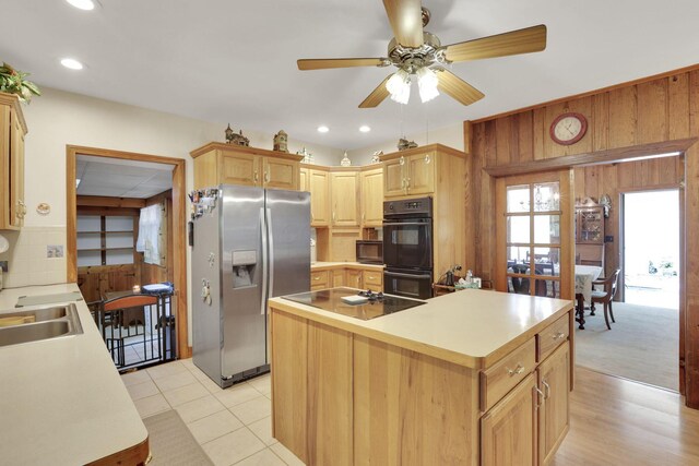 2083 Welsh Hills Rd, Granville, OH 43023 - kitchen featuring black appliances, wooden walls, a center island, a ceiling fan, and light countertops