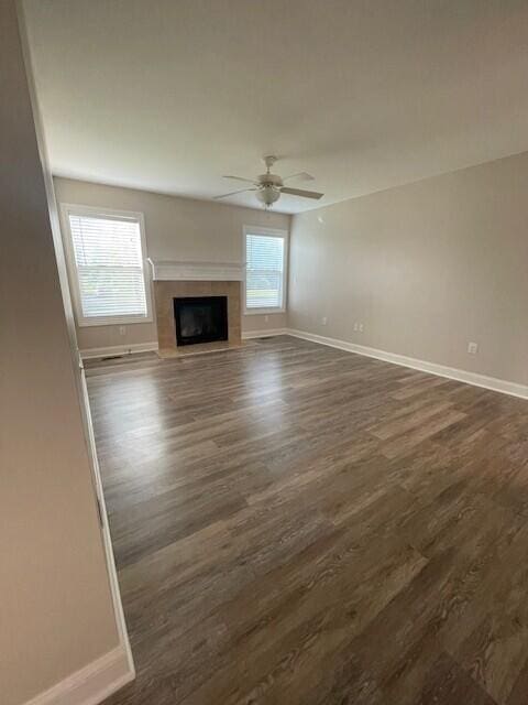 332 Bottecchia Blvd, Johnstown, OH 43031 - unfurnished living room with dark wood-style flooring, a ceiling fan, and a tiled fireplace