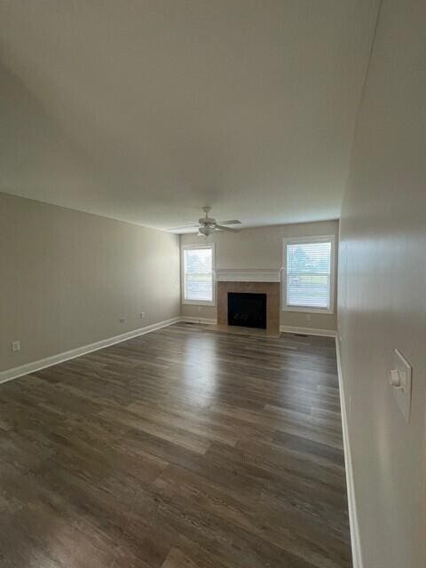 332 Bottecchia Blvd, Johnstown, OH 43031 - unfurnished living room featuring dark wood finished floors, a fireplace with flush hearth, and a ceiling fan