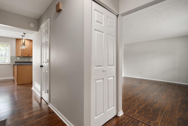 2268 Worthingwoods Blvd, Powell, OH 43065 - hallway featuring dark wood-type flooring and a textured ceiling
