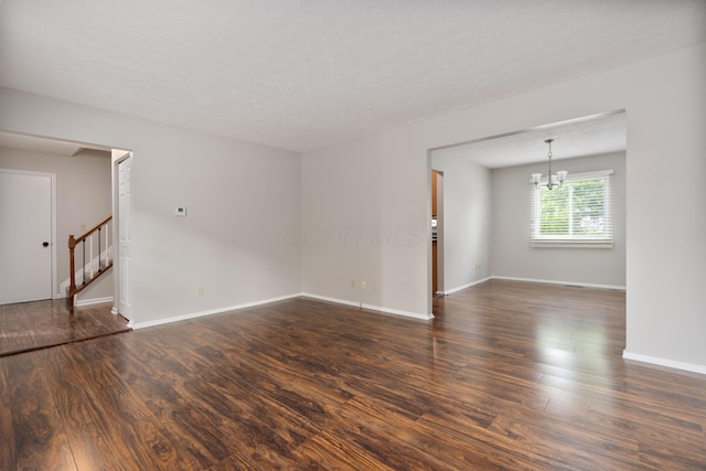 2268 Worthingwoods Blvd, Powell, OH 43065 - unfurnished room with dark wood-style floors, stairs, and a chandelier