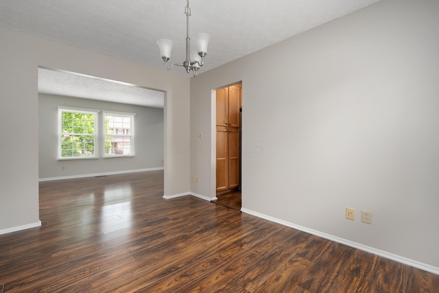 2268 Worthingwoods Blvd, Powell, OH 43065 - spare room with dark wood-style floors, a chandelier, and a textured ceiling
