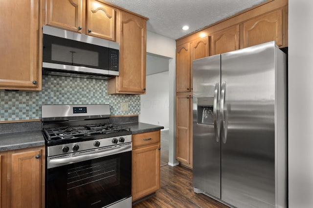 2268 Worthingwoods Blvd, Powell, OH 43065 - kitchen featuring appliances with stainless steel finishes, dark countertops, dark wood finished floors, backsplash, and recessed lighting