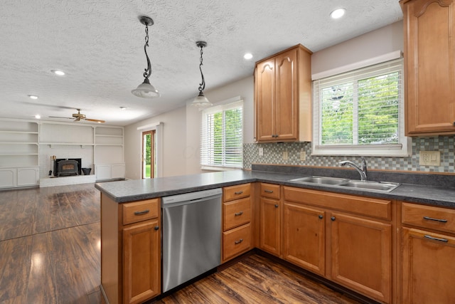 2268 Worthingwoods Blvd, Powell, OH 43065 - kitchen featuring dishwasher, a peninsula, dark wood-style floors, dark countertops, and tasteful backsplash