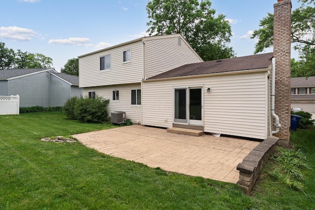 2268 Worthingwoods Blvd, Powell, OH 43065 - rear view of house featuring a patio, a lawn, a chimney, entry steps, and roof with shingles