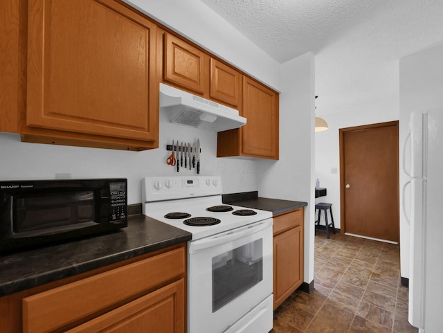 865 Westbury Ln S Unit 12B, Columbus, OH 43228 - kitchen with white appliances, under cabinet range hood, dark countertops, stone finish flooring, and brown cabinets