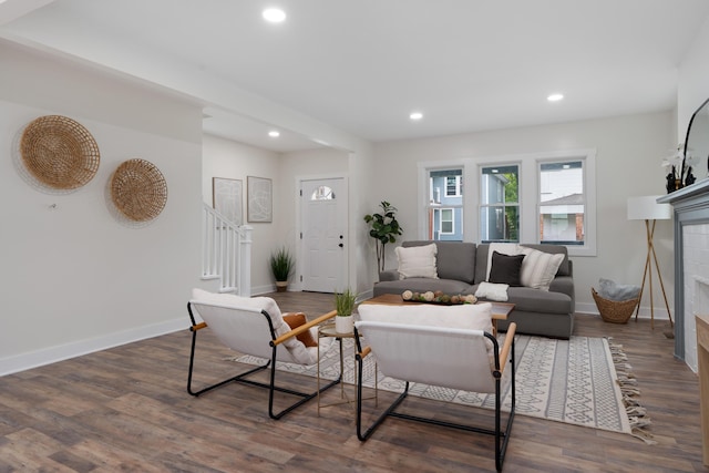 1591 Franklin Ave, Columbus, OH 43205 - living room with a tiled fireplace, recessed lighting, dark wood-type flooring, and stairway