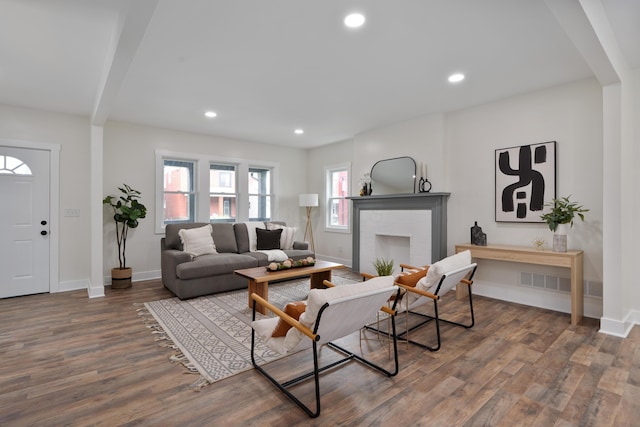 1591 Franklin Ave, Columbus, OH 43205 - living area featuring wood finished floors, recessed lighting, a brick fireplace, and beamed ceiling
