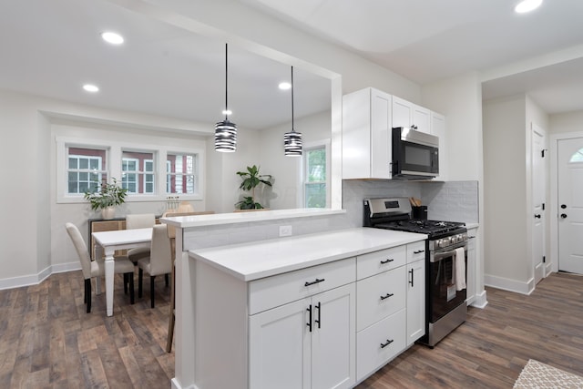 1591 Franklin Ave, Columbus, OH 43205 - kitchen featuring appliances with stainless steel finishes, dark wood-style floors, tasteful backsplash, recessed lighting, and white cabinets