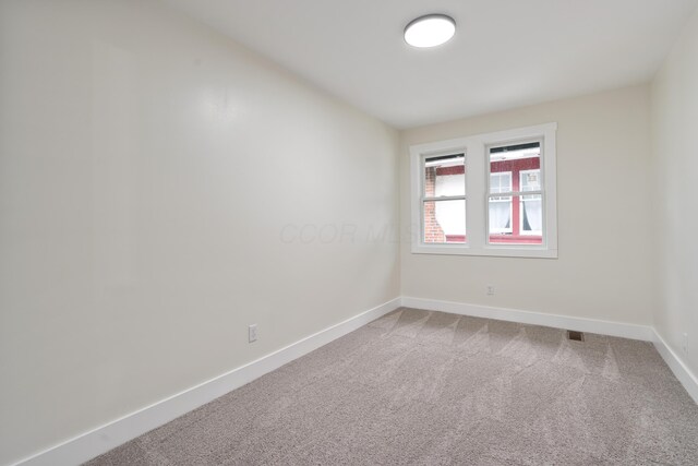 1591 Franklin Ave, Columbus, OH 43205 - unfurnished room featuring baseboards and light colored carpet