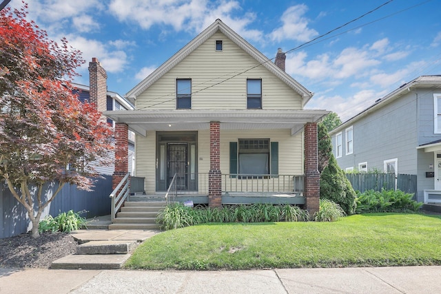 649 E 11th Ave, Columbus, OH 43211 - view of front of home featuring covered porch and a chimney
