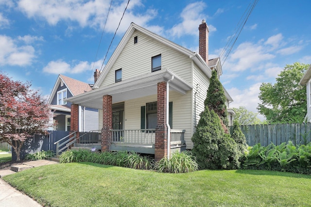 649 E 11th Ave, Columbus, OH 43211 - bungalow-style home with covered porch and a chimney