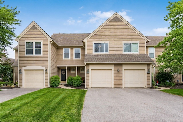 3381 Fishinger Mill Dr, Hilliard, OH 43026 - townhome / multi-family property with driveway, a garage, a front yard, and roof with shingles