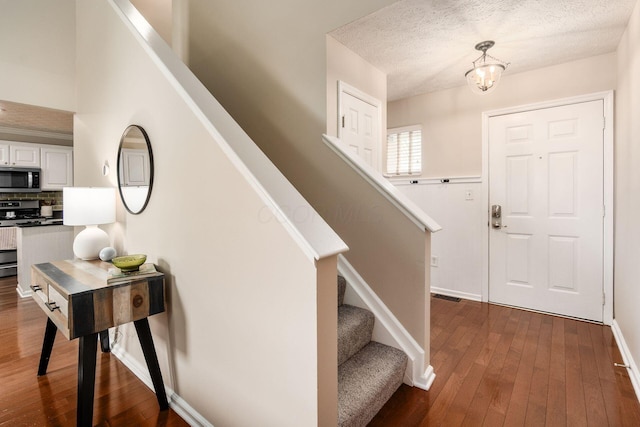 3381 Fishinger Mill Dr, Hilliard, OH 43026 - foyer entrance with dark wood-style floors, stairway, and a textured ceiling