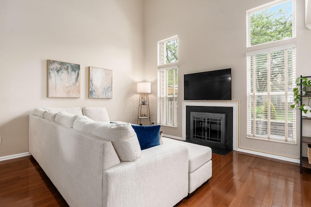 3381 Fishinger Mill Dr, Hilliard, OH 43026 - living area featuring a high ceiling, plenty of natural light, dark wood-type flooring, and a fireplace with flush hearth