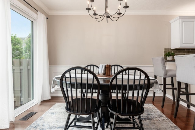3381 Fishinger Mill Dr, Hilliard, OH 43026 - dining space with a chandelier, ornamental molding, wainscoting, and wood finished floors