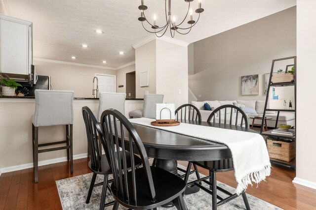 3381 Fishinger Mill Dr, Hilliard, OH 43026 - dining room featuring crown molding, recessed lighting, wood finished floors, and a chandelier