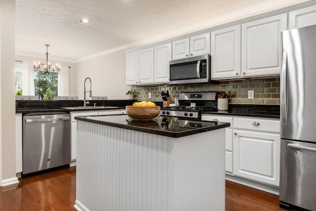 3381 Fishinger Mill Dr, Hilliard, OH 43026 - kitchen with appliances with stainless steel finishes, ornamental molding, backsplash, white cabinets, and dark wood-type flooring