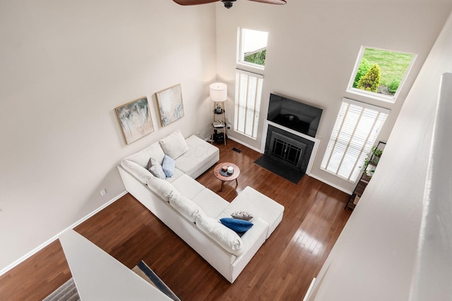 3381 Fishinger Mill Dr, Hilliard, OH 43026 - living room with a ceiling fan, plenty of natural light, a towering ceiling, a fireplace with flush hearth, and wood finished floors