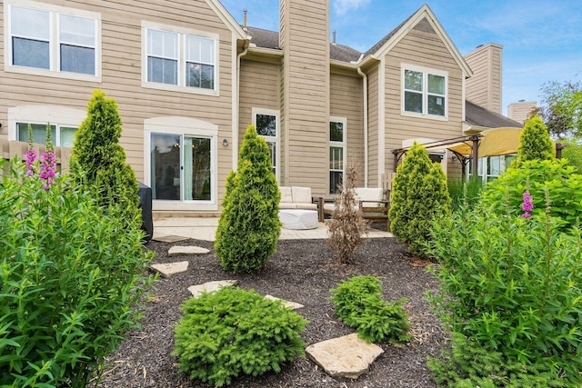 3381 Fishinger Mill Dr, Hilliard, OH 43026 - rear view of house with a chimney and a patio area