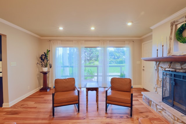 120 Hickory Ln, Lancaster, OH 43130 - sitting room with crown molding, light wood-style floors, a stone fireplace, and recessed lighting