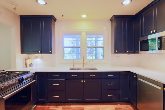 120 Hickory Ln, Lancaster, OH 43130 - kitchen featuring appliances with stainless steel finishes, light countertops, backsplash, light wood-style floors, and blue cabinets