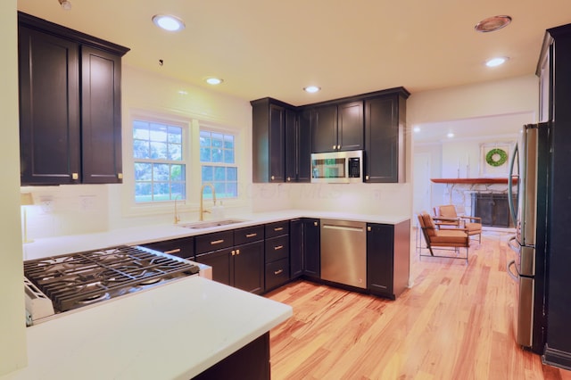 120 Hickory Ln, Lancaster, OH 43130 - kitchen with stainless steel appliances, light wood finished floors, tasteful backsplash, light countertops, and recessed lighting